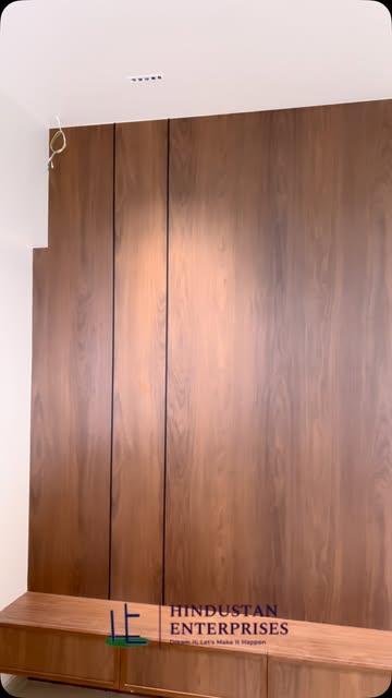 Wood-panel feature and low storage unit at the Kharadi interior project