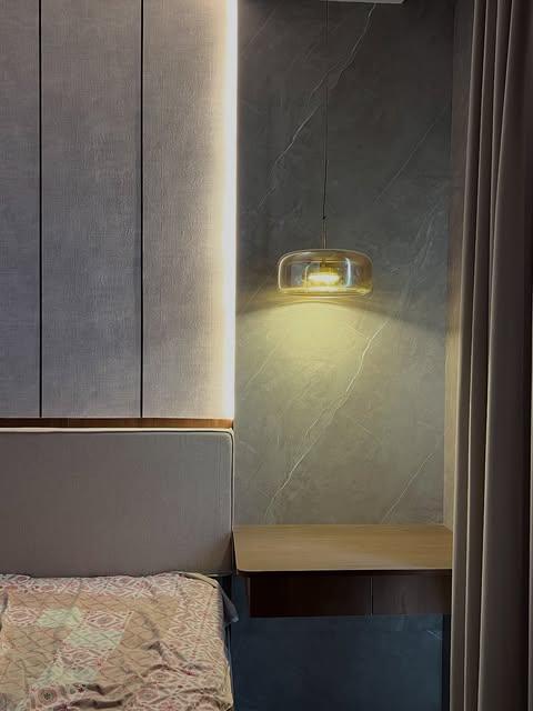 Bedroom side-table and wall-light detail at the Viman Nagar project
